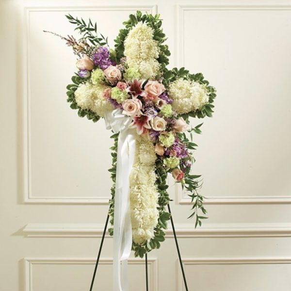 Solid White Standing Cross With Pastel Flower Break by local florist Where The Blooms Are In Levittown PA. Servicing Langhorne